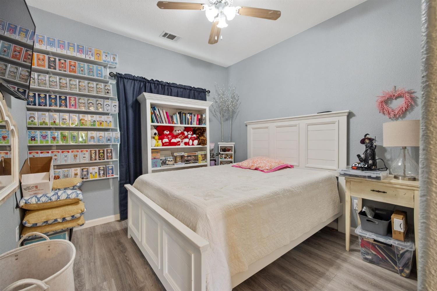1963 West Merritt Street Hanford, CA 93230 - Photo 17 of 32 a bedroom with a bed dresser and a chandelier