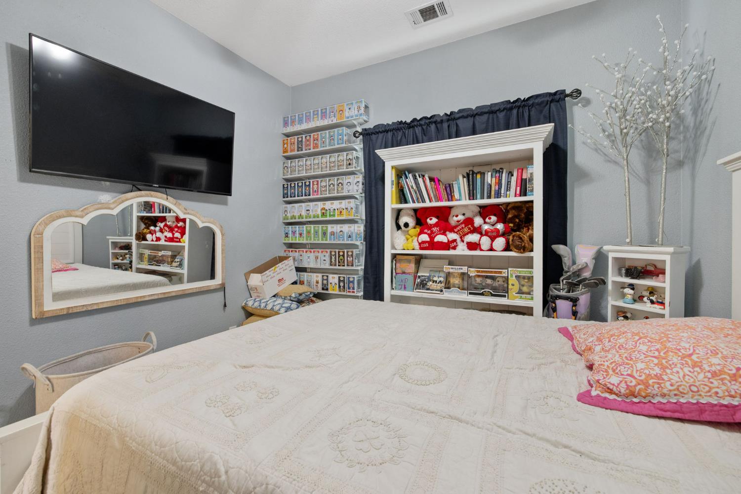 1963 West Merritt Street Hanford, CA 93230 - Photo 18 of 32 a bedroom with a bed and a flat screen tv