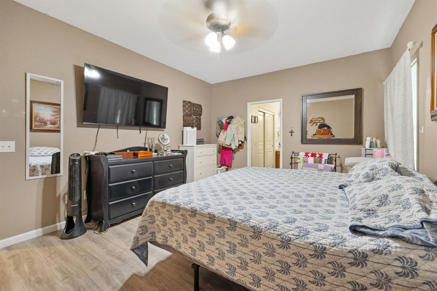1963 West Merritt Street Hanford, CA 93230 - Photo 20 of 32 a bedroom with a bed and a flat screen tv