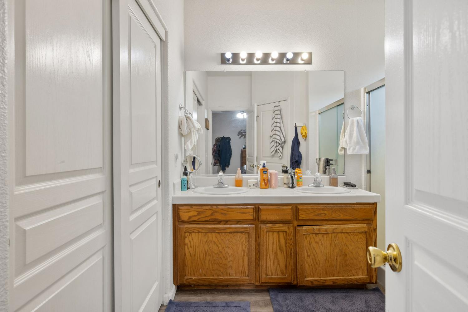 1963 West Merritt Street Hanford, CA 93230 - Photo 21 of 32 a view of living room with granite countertop a mirror and a sink