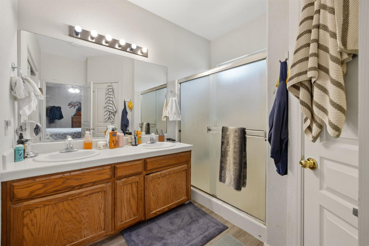 1963 West Merritt Street Hanford, CA 93230 - Photo 22 of 32 a bathroom with a double vanity sink and mirror