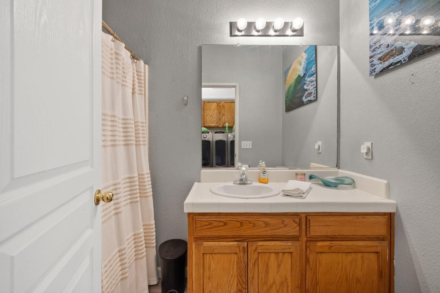 1963 West Merritt Street Hanford, CA 93230 - Photo 24 of 32 a bathroom with a sink vanity and a mirror