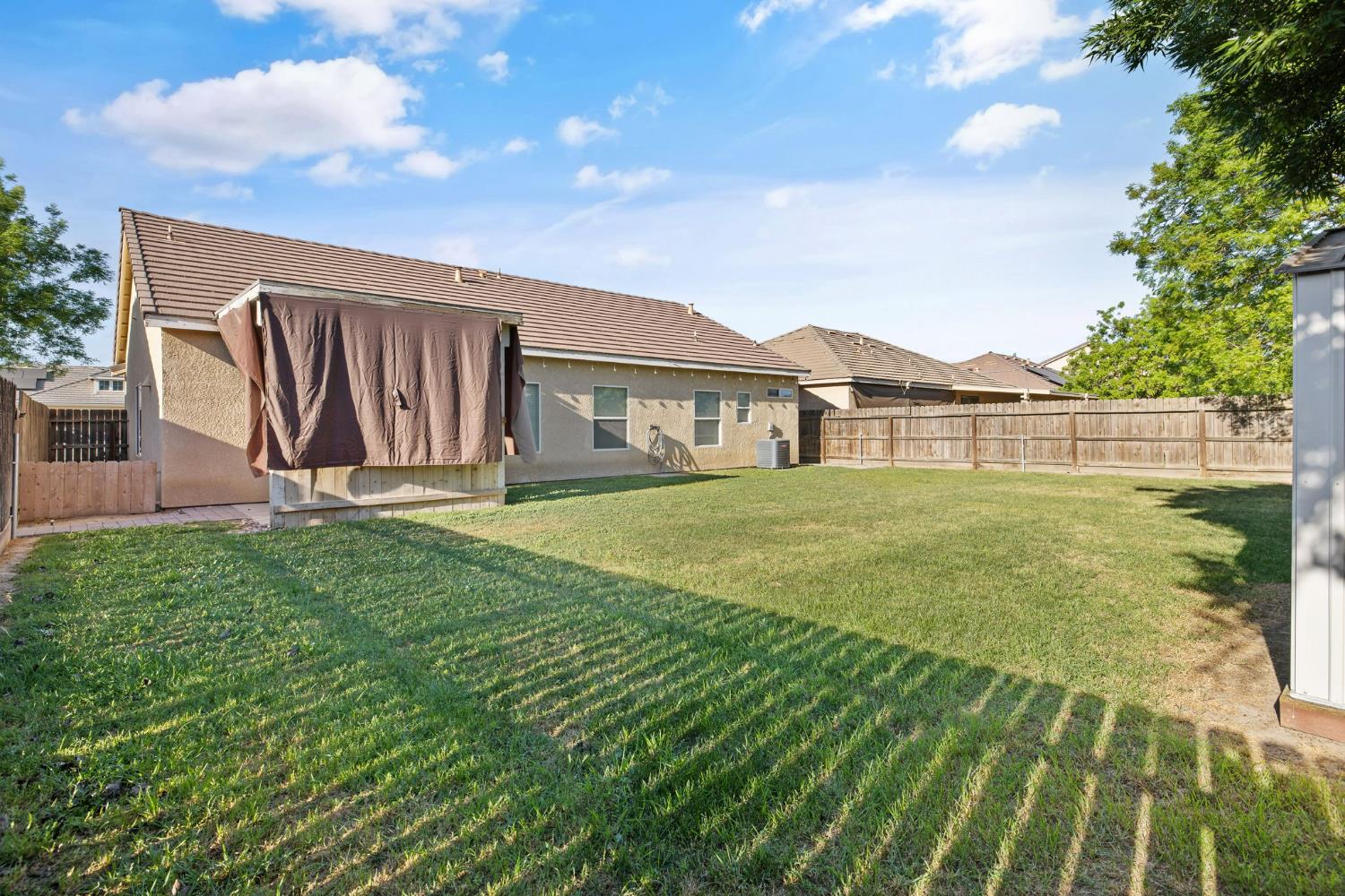 1963 West Merritt Street Hanford, CA 93230 - Photo 30 of 32 a view of a house with a yard