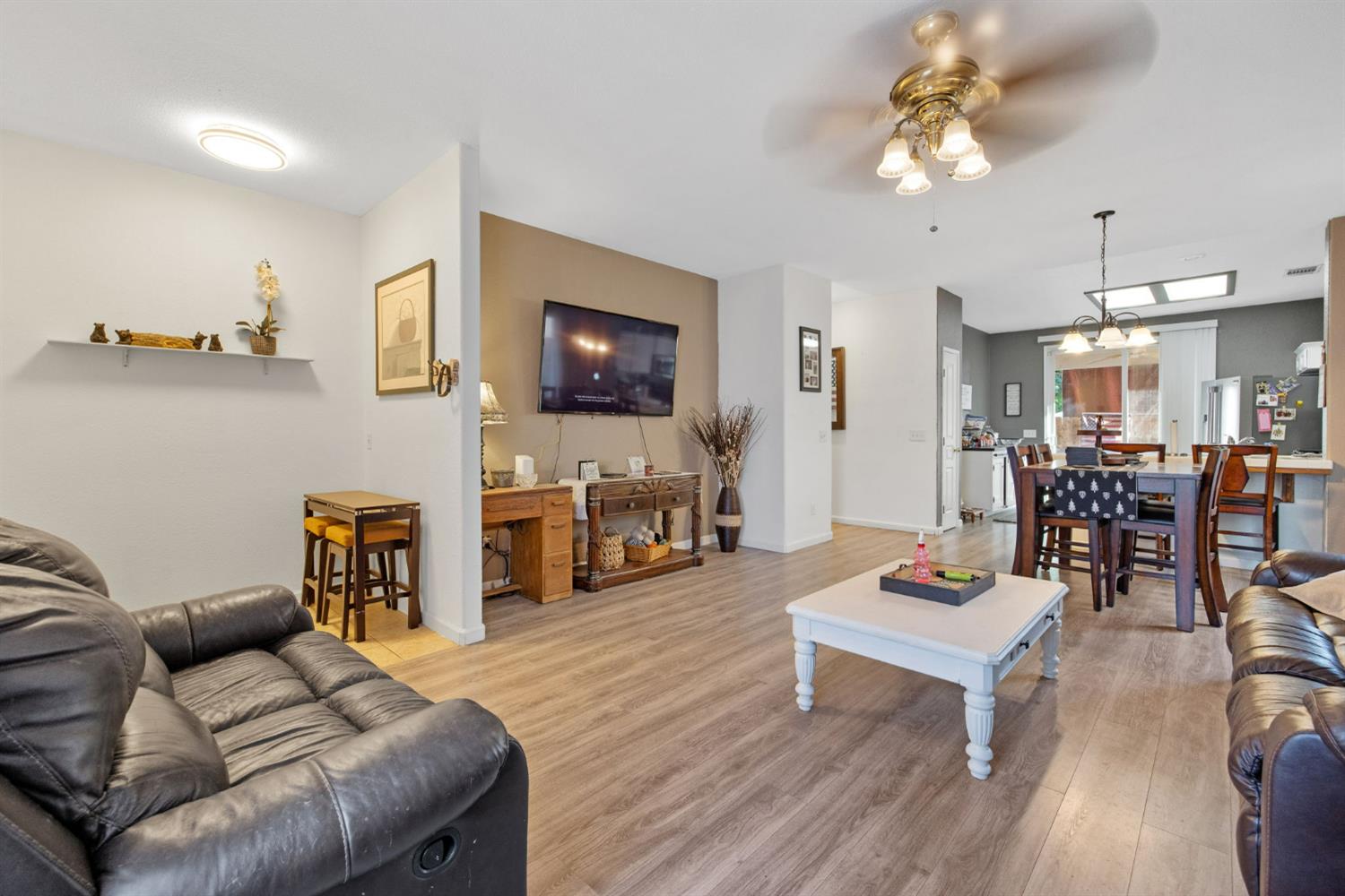 1963 West Merritt Street Hanford, CA 93230 - Photo 8 of 32 a living room with furniture and a flat screen tv with kitchen view
