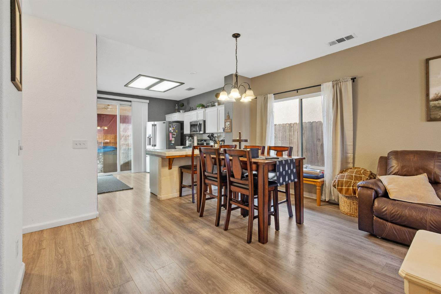 1963 West Merritt Street Hanford, CA 93230 - Photo 10 of 32 a view of a dining room with furniture window and wooden floor