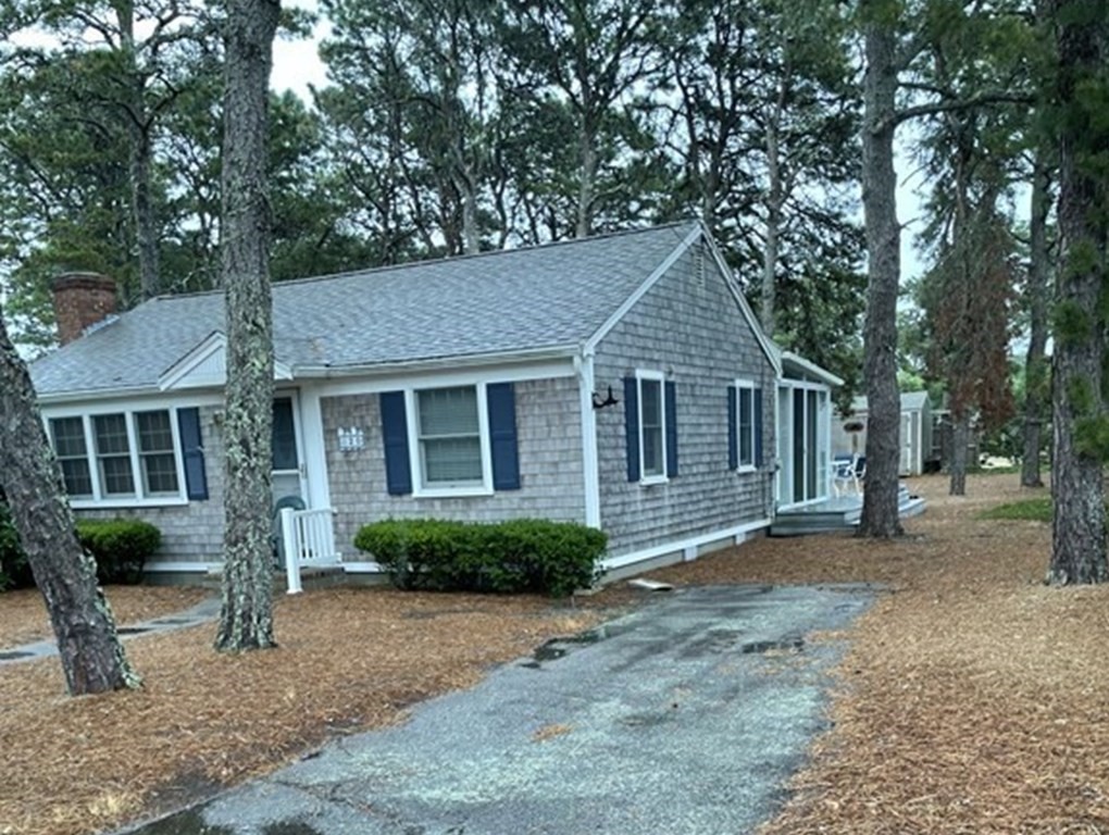 20 Lawrence Road Dennis Port, MA 02639 - Photo 2 of 29 a front view of a house with a garden and trees
