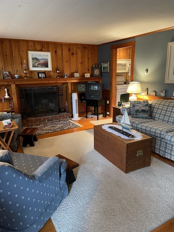 20 Lawrence Road Dennis Port, MA 02639 - Photo 4 of 29 a living room with furniture a fireplace and a flat screen tv