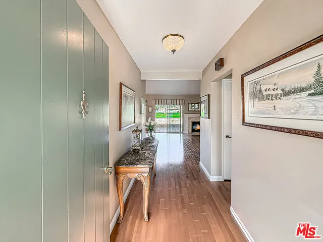 a living room with furniture a fireplace and a table