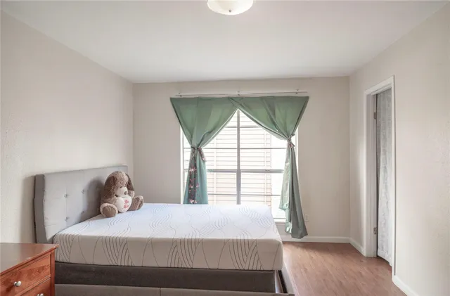 a bedroom with a bed and a window