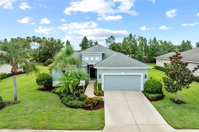 an aerial view of a house with garden space and outdoor seating