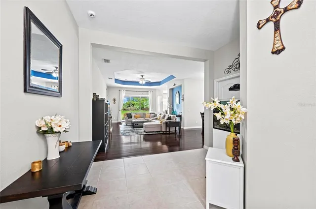 a living room with furniture dining table and a flat screen tv