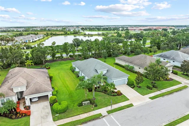 an aerial view of a house with a yard