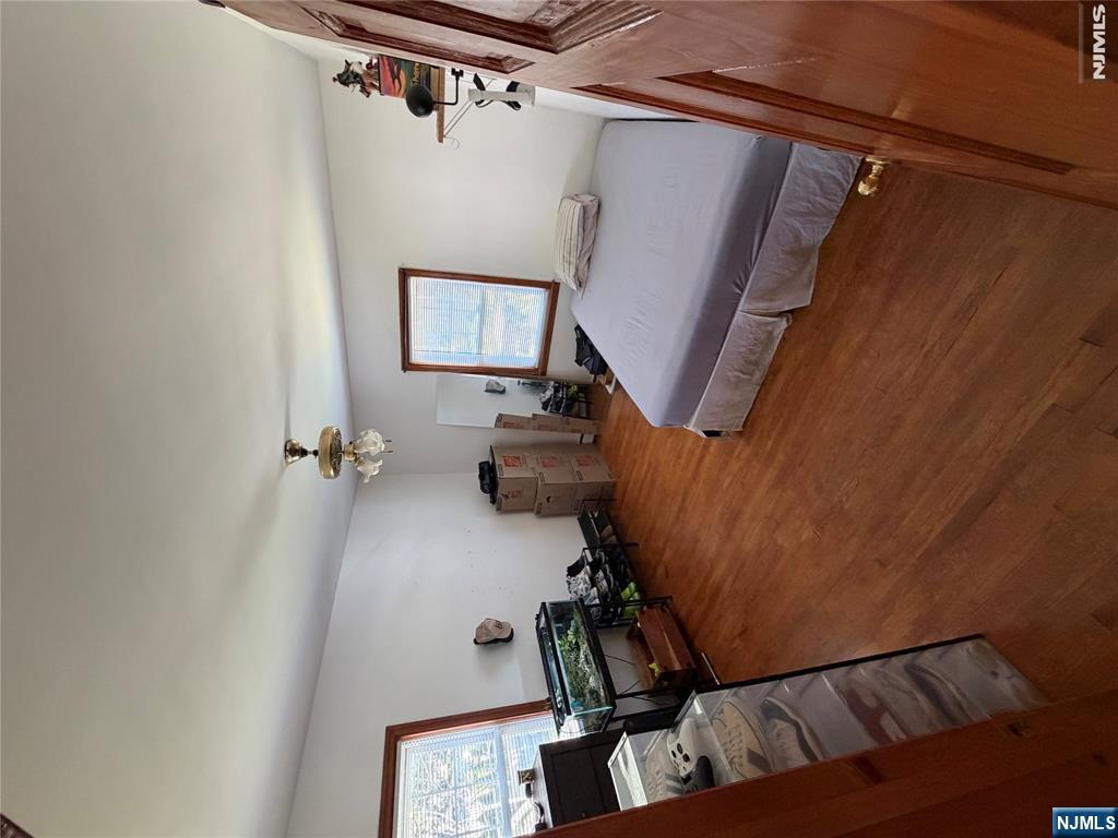 734 Clark Avenue Ridgefield, NJ 07657 - Photo 10 of 12 a bedroom with a bed and wooden floor