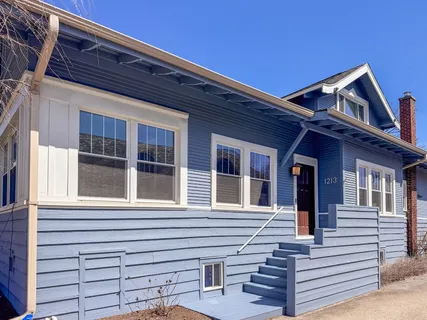 a view of a house with a large window and stairs