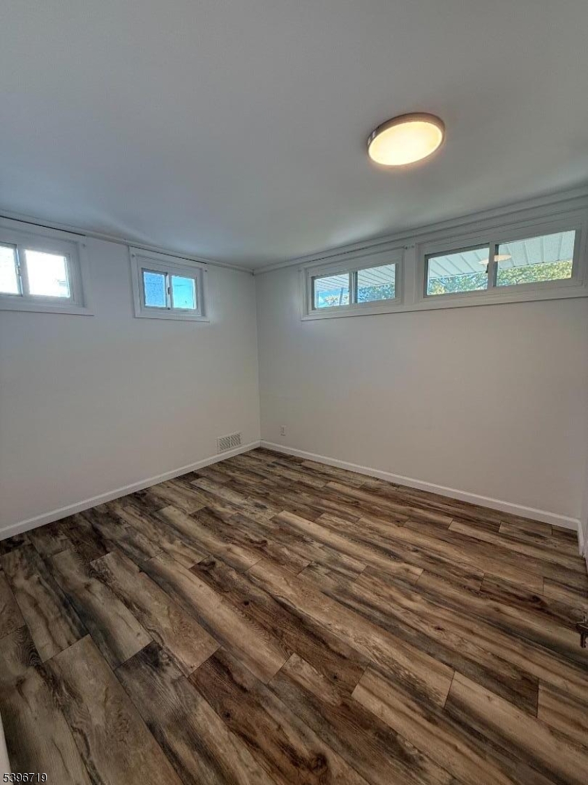 201 4th Street Clifton, NJ 07011 - Photo 7 of 8 a view of a livingroom with wooden floor