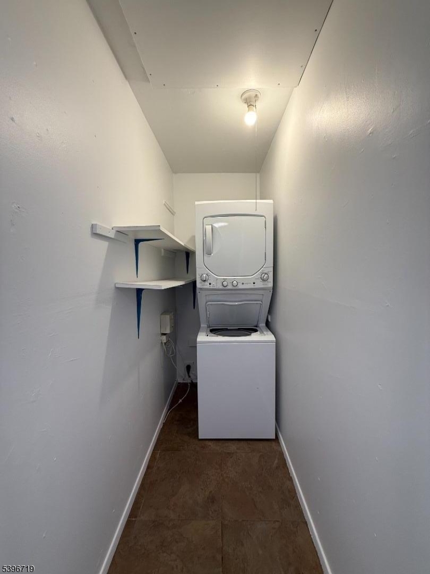 201 4th Street Clifton, NJ 07011 - Photo 8 of 8 a room with furniture and a lamp