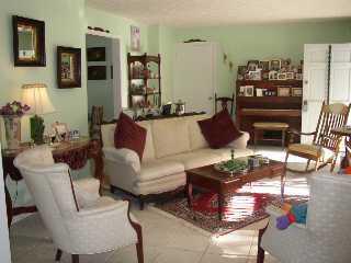 4935 Southeast Manatee Cove Road Stuart, FL 34997 - Photo 2 of 4 a living room with furniture and a flat screen tv
