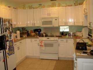 4935 Southeast Manatee Cove Road Stuart, FL 34997 - Photo 4 of 4 a kitchen with appliances a sink and cabinets