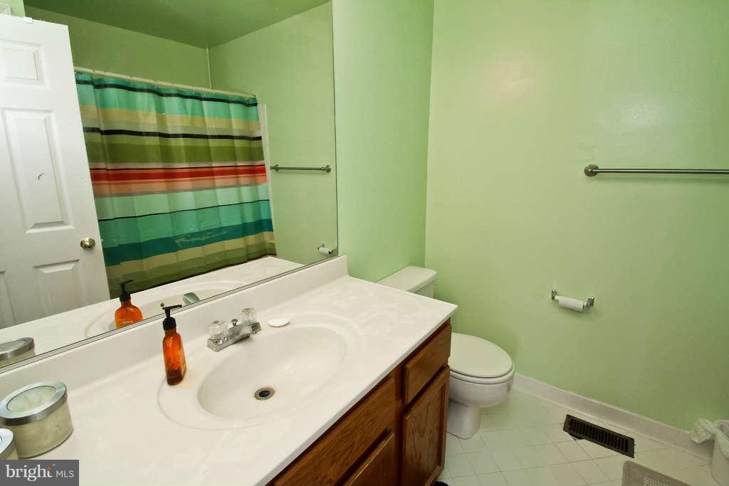 4739 Ridgeline Terrace, Unit 301 Bowie, MD 20720 - Photo 14 of 25 a bathroom with a sink a toilet and shower
