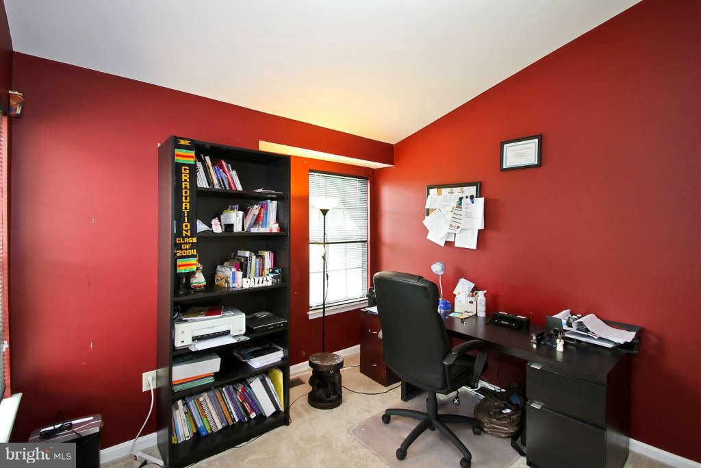 4739 Ridgeline Terrace, Unit 301 Bowie, MD 20720 - Photo 16 of 25 a workspace with furniture and lamp
