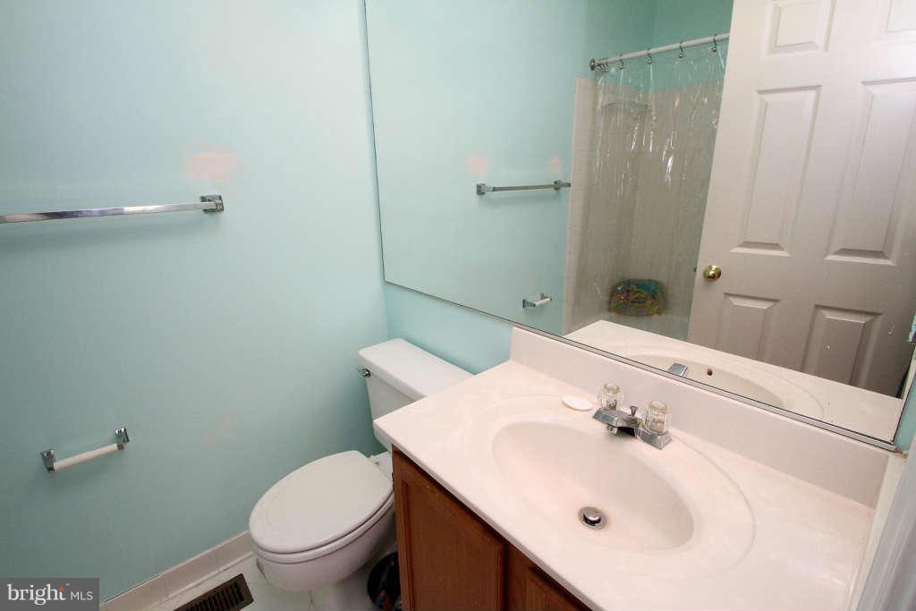 4739 Ridgeline Terrace, Unit 301 Bowie, MD 20720 - Photo 18 of 25 a bathroom with a sink toilet and shower