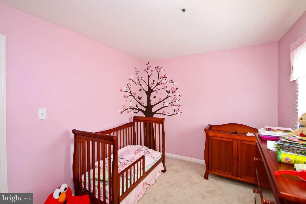 4739 Ridgeline Terrace, Unit 301 Bowie, MD 20720 - Photo 20 of 25 a bedroom with furniture and a window