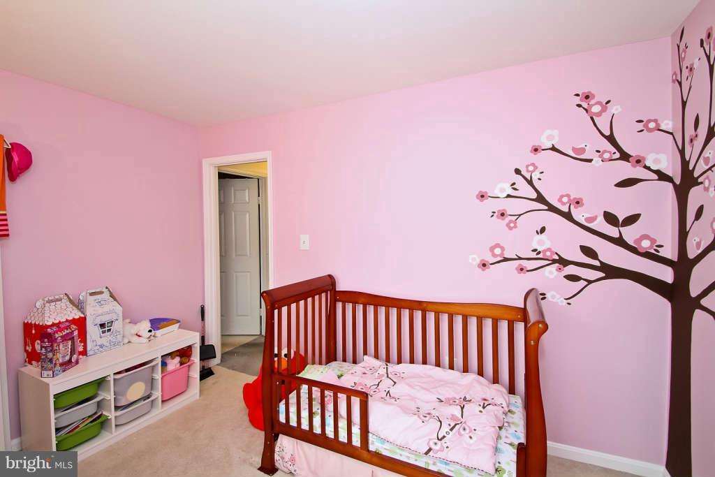 4739 Ridgeline Terrace, Unit 301 Bowie, MD 20720 - Photo 21 of 25 a bedroom with a bed and a window
