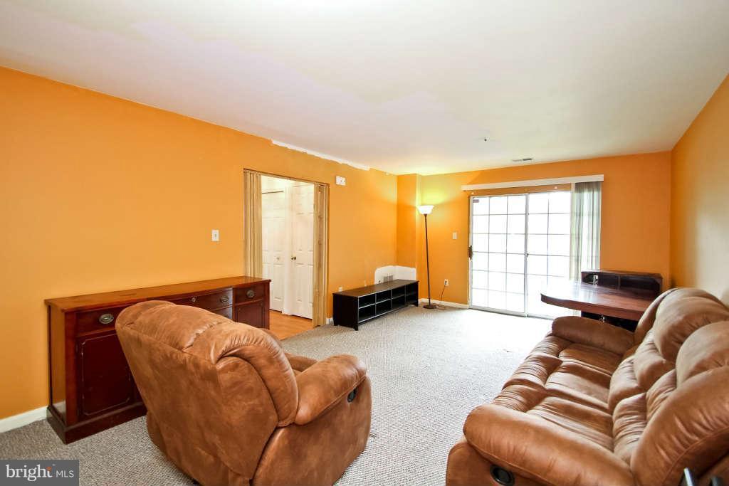 4739 Ridgeline Terrace, Unit 301 Bowie, MD 20720 - Photo 23 of 25 a living room with furniture and a large window