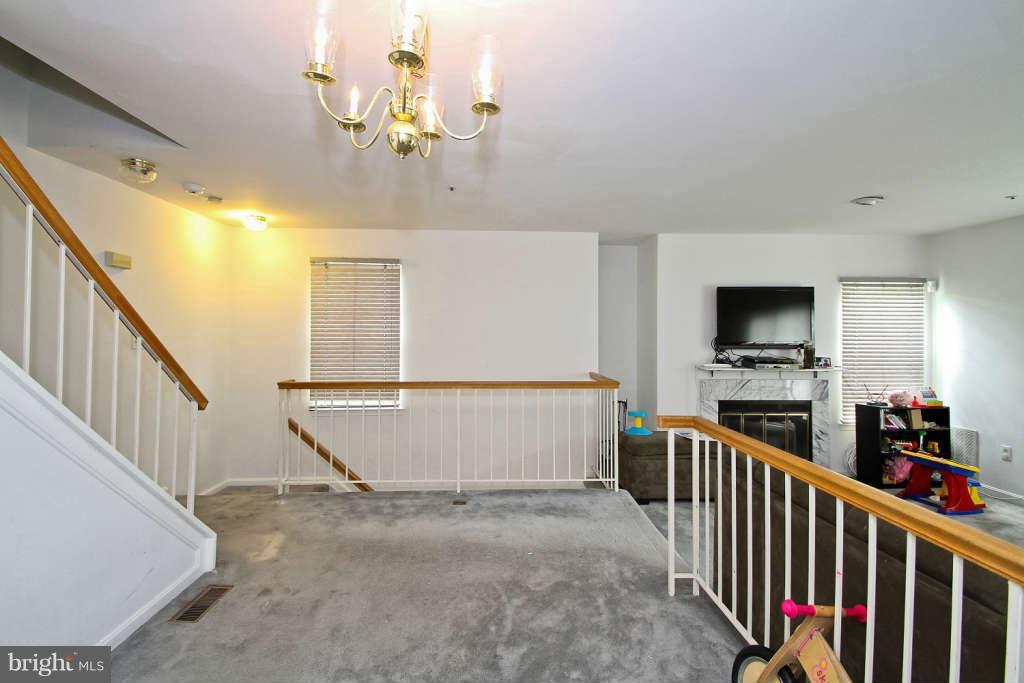 4739 Ridgeline Terrace, Unit 301 Bowie, MD 20720 - Photo 6 of 25 a view of a living room and a window with stairs