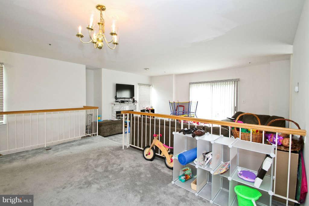 4739 Ridgeline Terrace, Unit 301 Bowie, MD 20720 - Photo 7 of 25 a bedroom with furniture a rug toys and windows