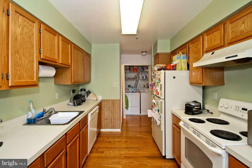 4739 Ridgeline Terrace, Unit 301 Bowie, MD 20720 - Photo 8 of 25 a kitchen with a sink a stove and cabinets
