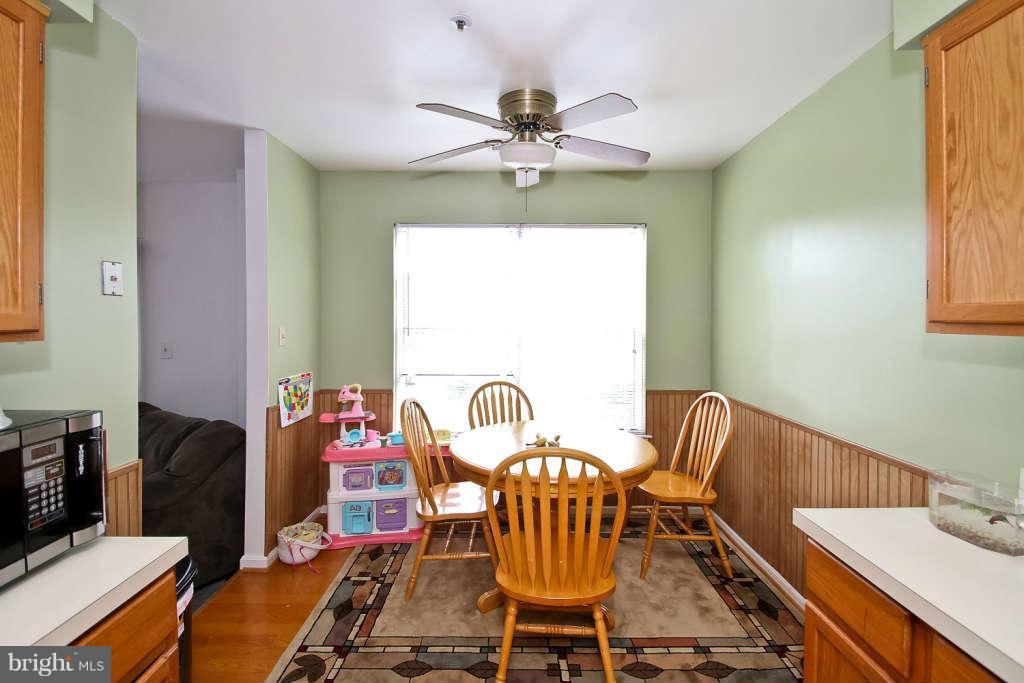 4739 Ridgeline Terrace, Unit 301 Bowie, MD 20720 - Photo 9 of 25 a view of a dining room with furniture window and outside view