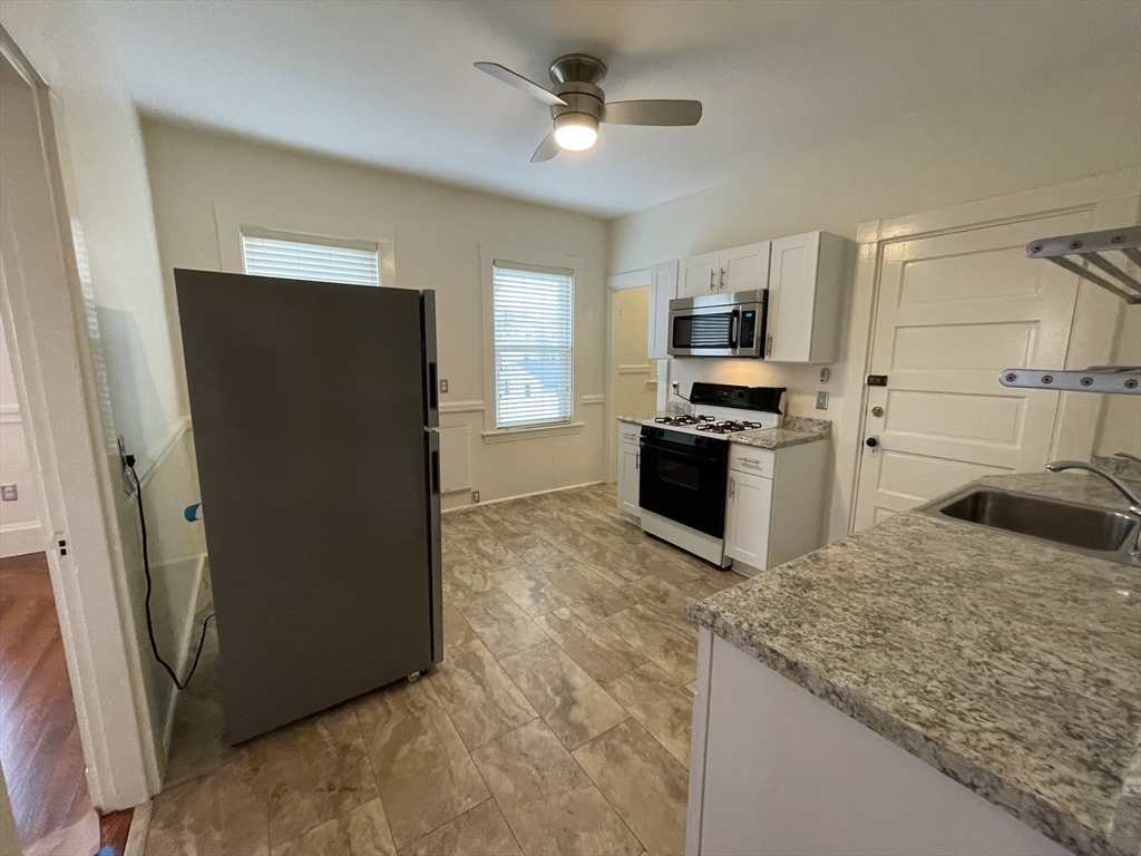 62 Ibbetson Street, Unit 3L Somerville, MA 02143 - Photo 13 of 20 a kitchen with stainless steel appliances granite countertop a refrigerator a stove and a sink
