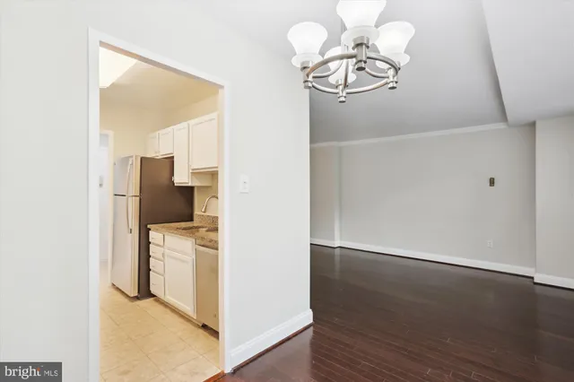 a view of kitchen and hallway with wooden floor
