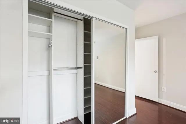 a view of walk in closet with empty racks