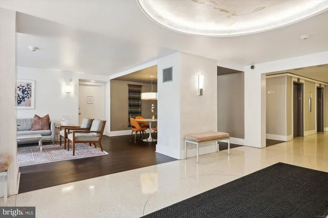 a living room with furniture and a large mirror
