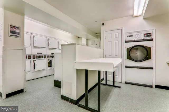 a kitchen with stainless steel appliances a white refrigerator and a stove top oven