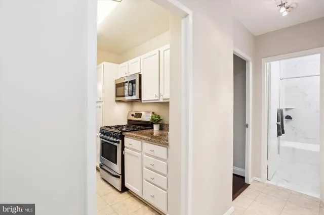 a kitchen with stainless steel appliances granite countertop a stove and a refrigerator