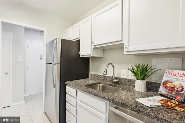 a kitchen with a refrigerator and a sink