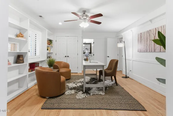 an empty room with ceiling fan and window