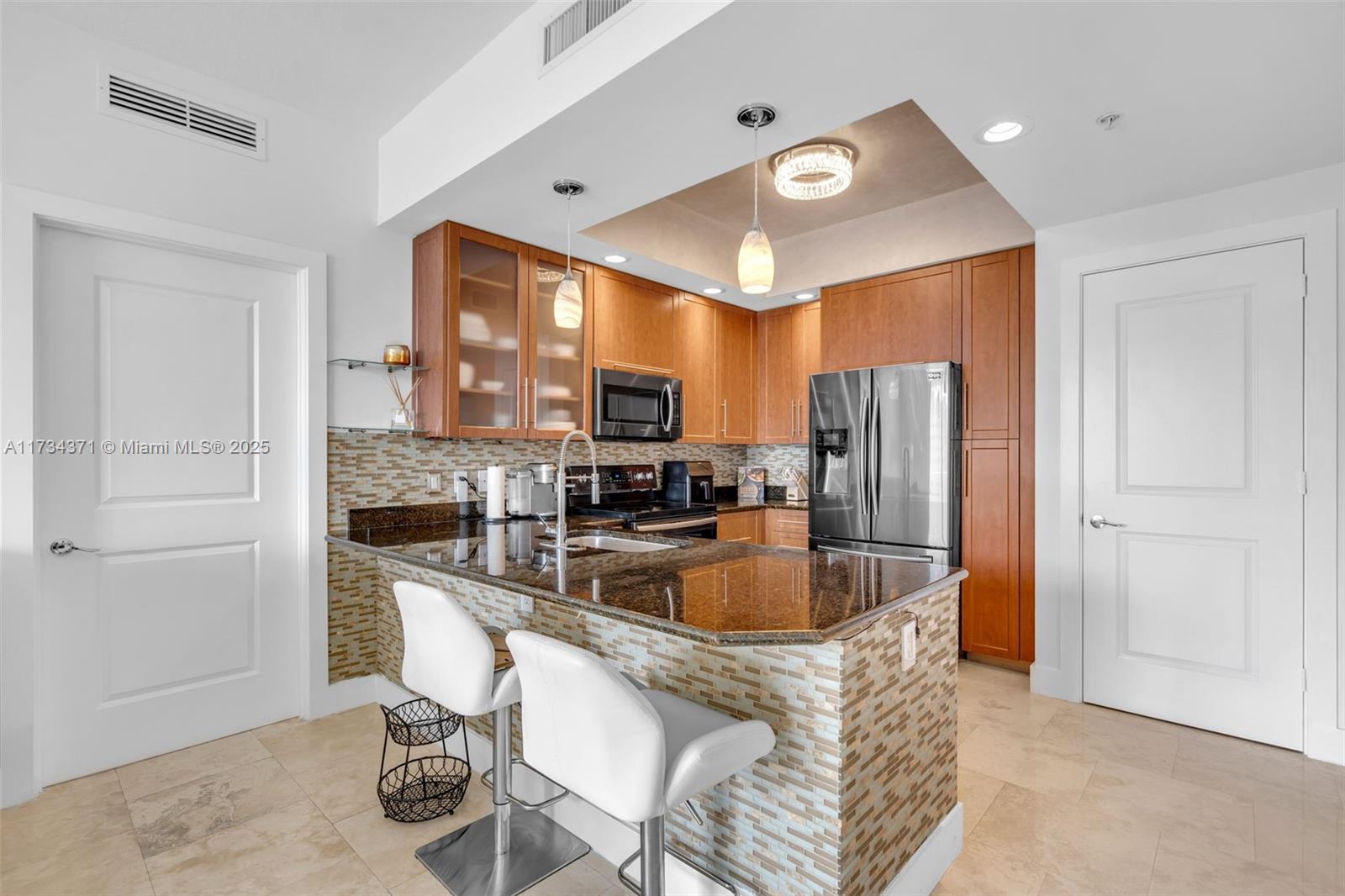 315 Northeast 3rd Avenue, Unit 1804 Fort Lauderdale, FL 33301 - Photo 13 of 20 a kitchen with stainless steel appliances granite countertop a sink refrigerator and cabinets