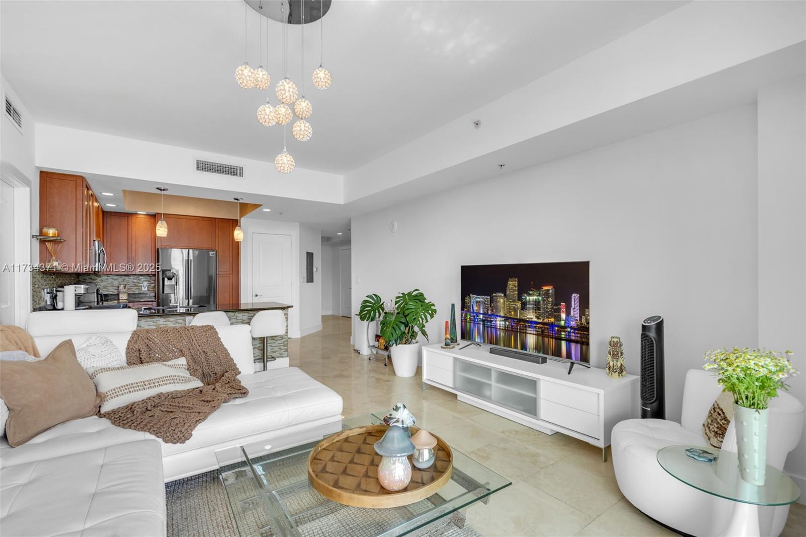 315 Northeast 3rd Avenue, Unit 1804 Fort Lauderdale, FL 33301 - Photo 14 of 20 a living room with furniture and a flat screen tv