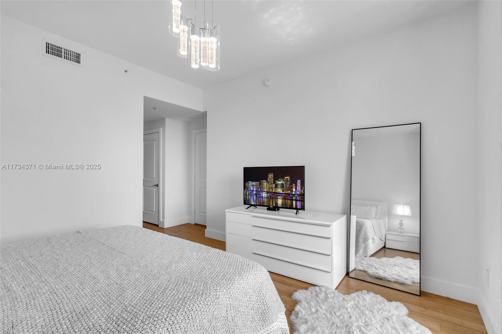 315 Northeast 3rd Avenue, Unit 1804 Fort Lauderdale, FL 33301 - Photo 4 of 20 a bedroom with a bed and a view of en suite bathroom