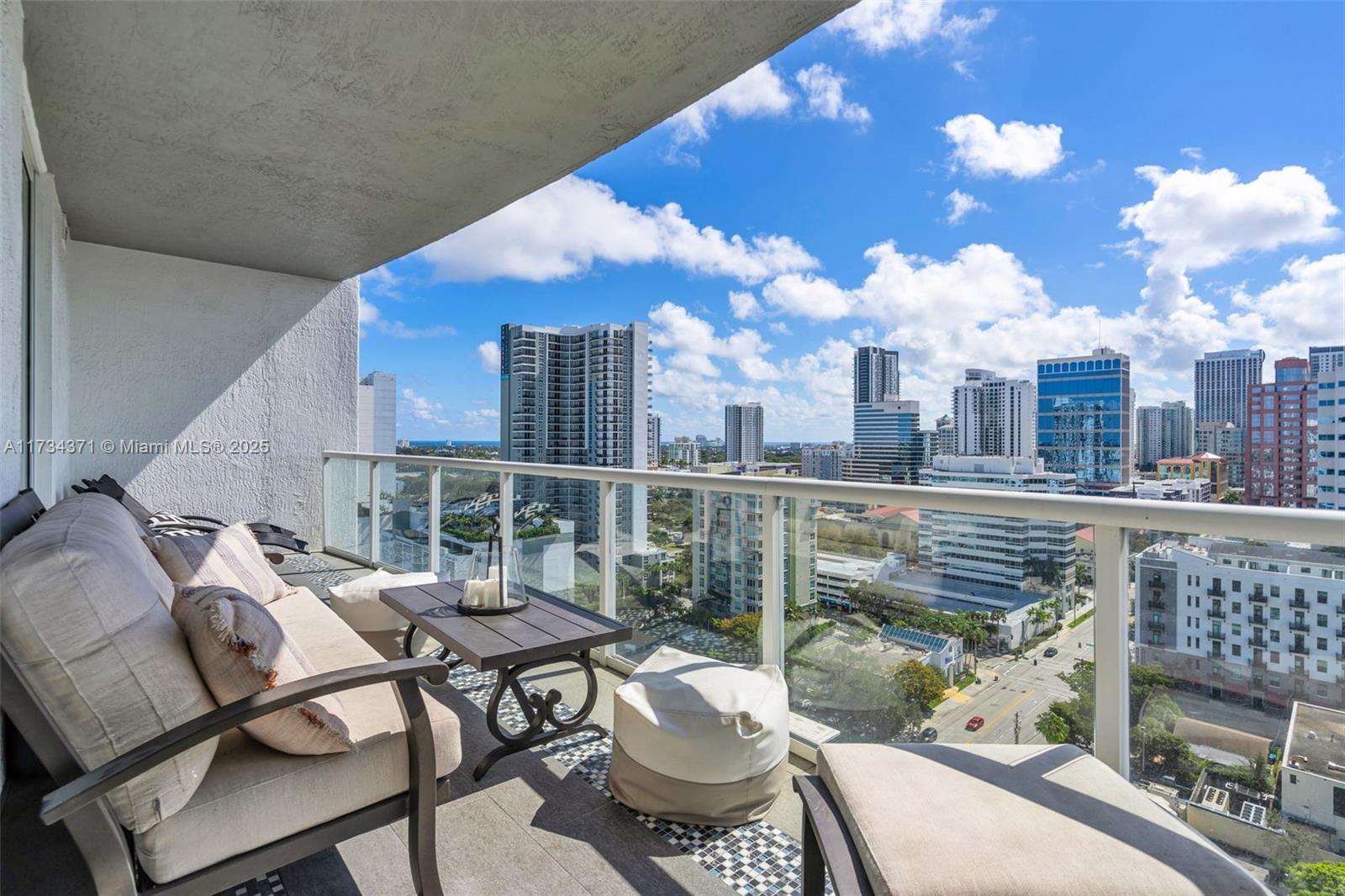 315 Northeast 3rd Avenue, Unit 1804 Fort Lauderdale, FL 33301 - Photo 8 of 20 a view of a balcony with two chairs and a potted plant