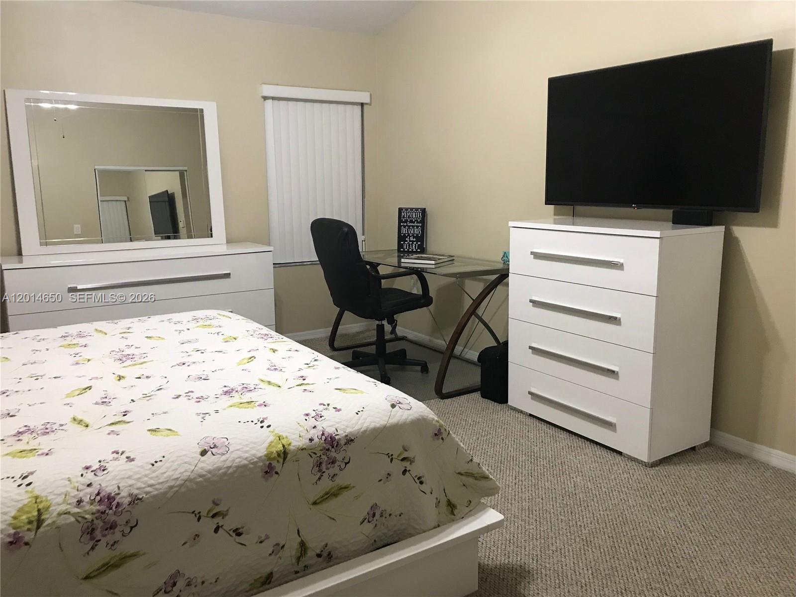 16654 Southwest 103rd Lane Miami, FL 33196 - Photo 13 of 20 a bedroom with a bed and a flat screen tv