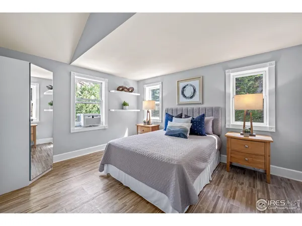 a bed sitting in a bedroom next to a window