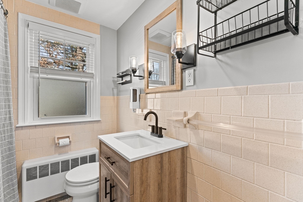 13 Cherry Hill Drive Seekonk, MA 02771 - Photo 16 of 40 a bathroom with a sink a toilet and a mirror