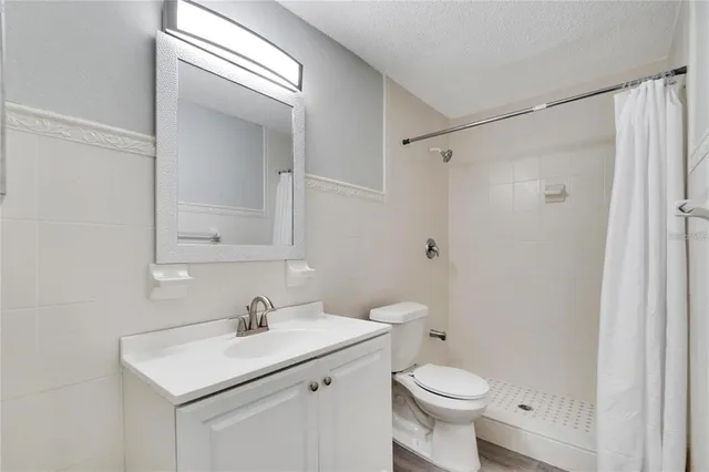 a bathroom with a sink toilet and a mirror