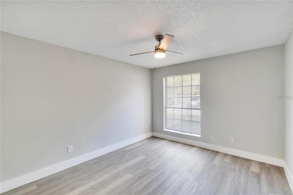 8718 Mallard Reserve Drive, Unit 101 Tampa, FL 33614 - Photo 15 of 25 wooden floor in an empty room with a window