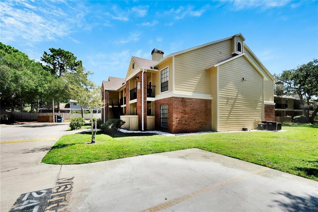8718 Mallard Reserve Drive, Unit 101 Tampa, FL 33614 - Photo 3 of 25 a front view of house with yard and green space